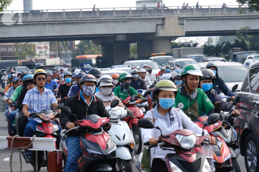 Hàng ngàn cha mẹ đội nắng chở con nhỏ về quê ăn Tết, các cửa ngõ Sài Gòn ùn ứ - Ảnh 6.