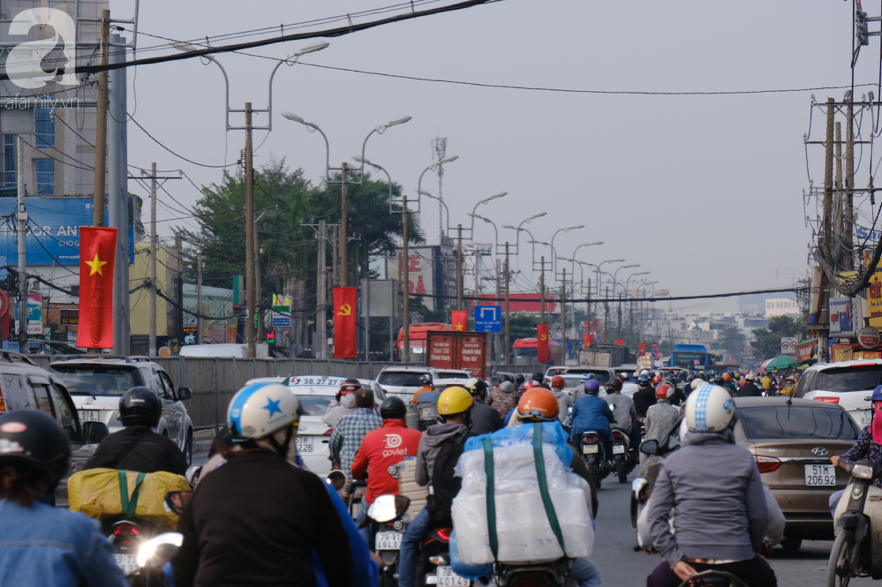 Hàng ngàn cha mẹ đội nắng chở con nhỏ về quê ăn Tết, các cửa ngõ Sài Gòn ùn ứ - Ảnh 4.