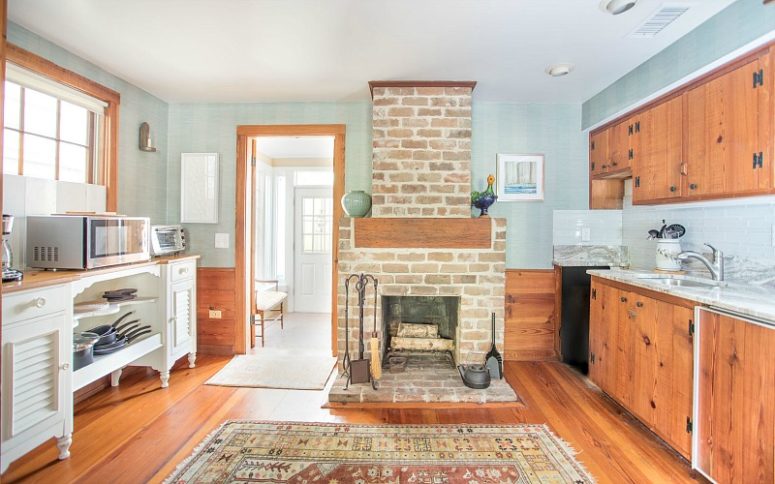 05-the-kitchen-is-done-with-rich-stained-cabinets-light-blue-walls-and-backsplashes-a-fireplace-that-is-working-775x484-15854971749971896481202.jpg