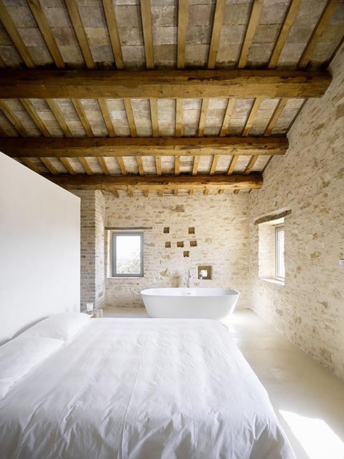 22-a-rural-provence-bedroom-with-much-stone-and-wood-and-a-bathtub-by-the-window-to-enjoy-the-views-15855579698231828351291.jpg