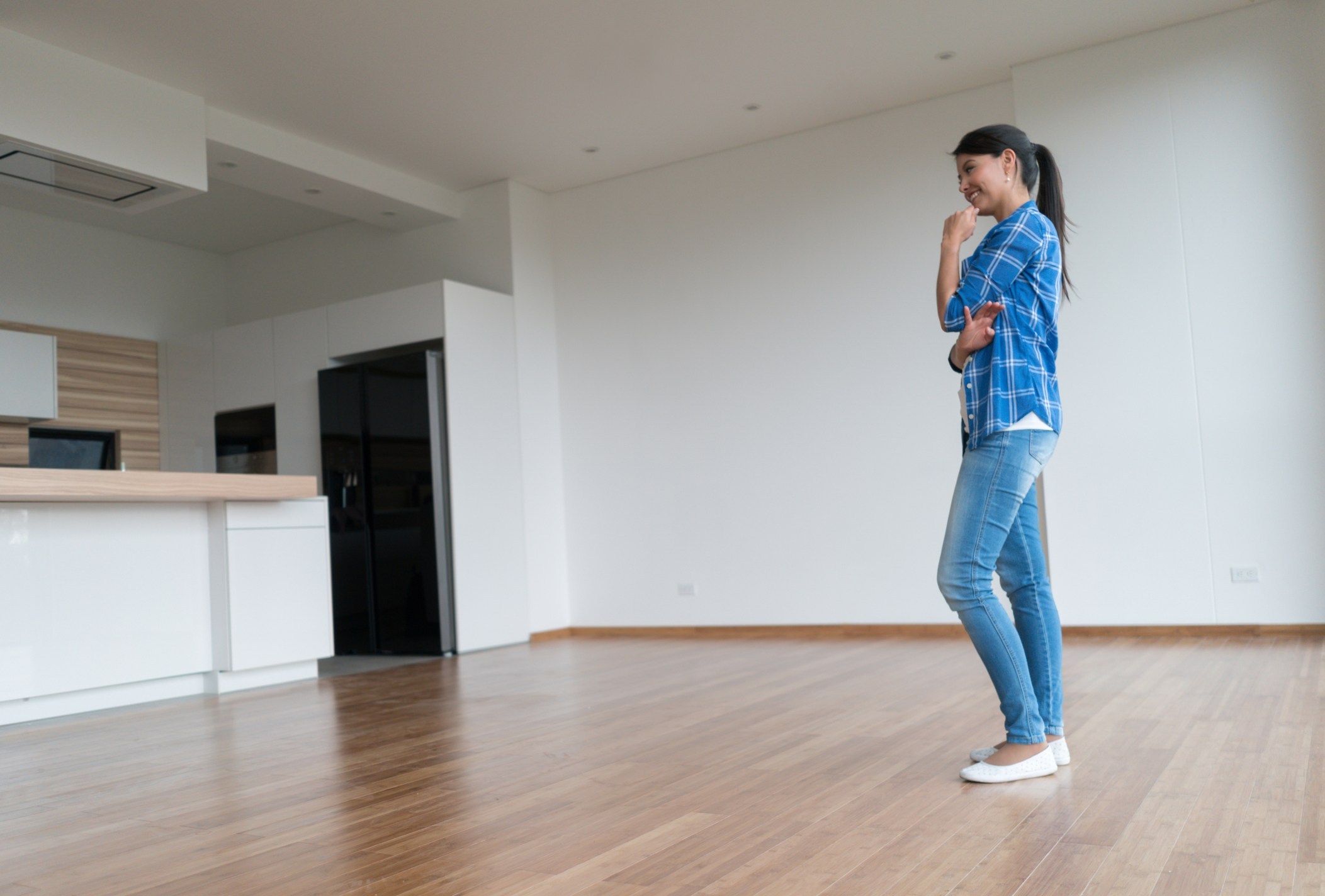 woman-blue-paid-shirt-in-empty-apartmentistock-1600401119392103075482.jpg