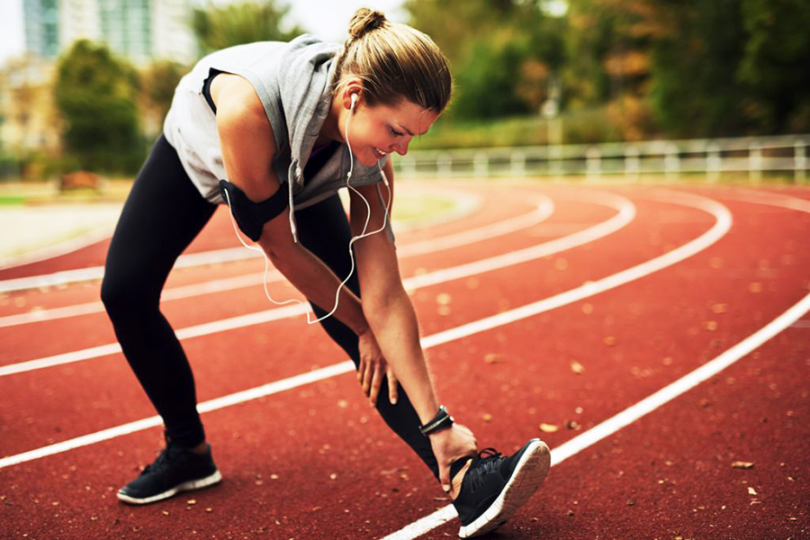 smiling-blonde-sportswoman-stretching.jpg