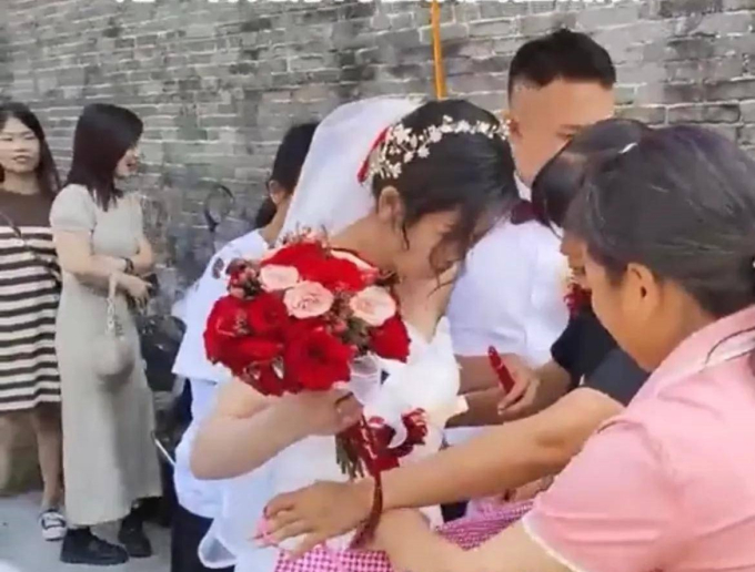Cô dâu vừa xuống xe hoa, người cô bên đàng trai làm hành động khiến cư dân mạng phẫn nộ: "Muốn con dâu phải phục vụ nhà chồng cả đời?" - Ảnh 3. Cô dâu vừa xuống xe hoa, người cô bên đàng trai làm hành động khiến cư dân mạng phẫn nộ: "Muốn con dâu phải phục vụ nhà chồng cả đời?" - Ảnh 3.
