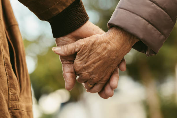 elderly-couple-holding-hands-and-16756769009391392025155-1675929321550-16759293217221007793072.png