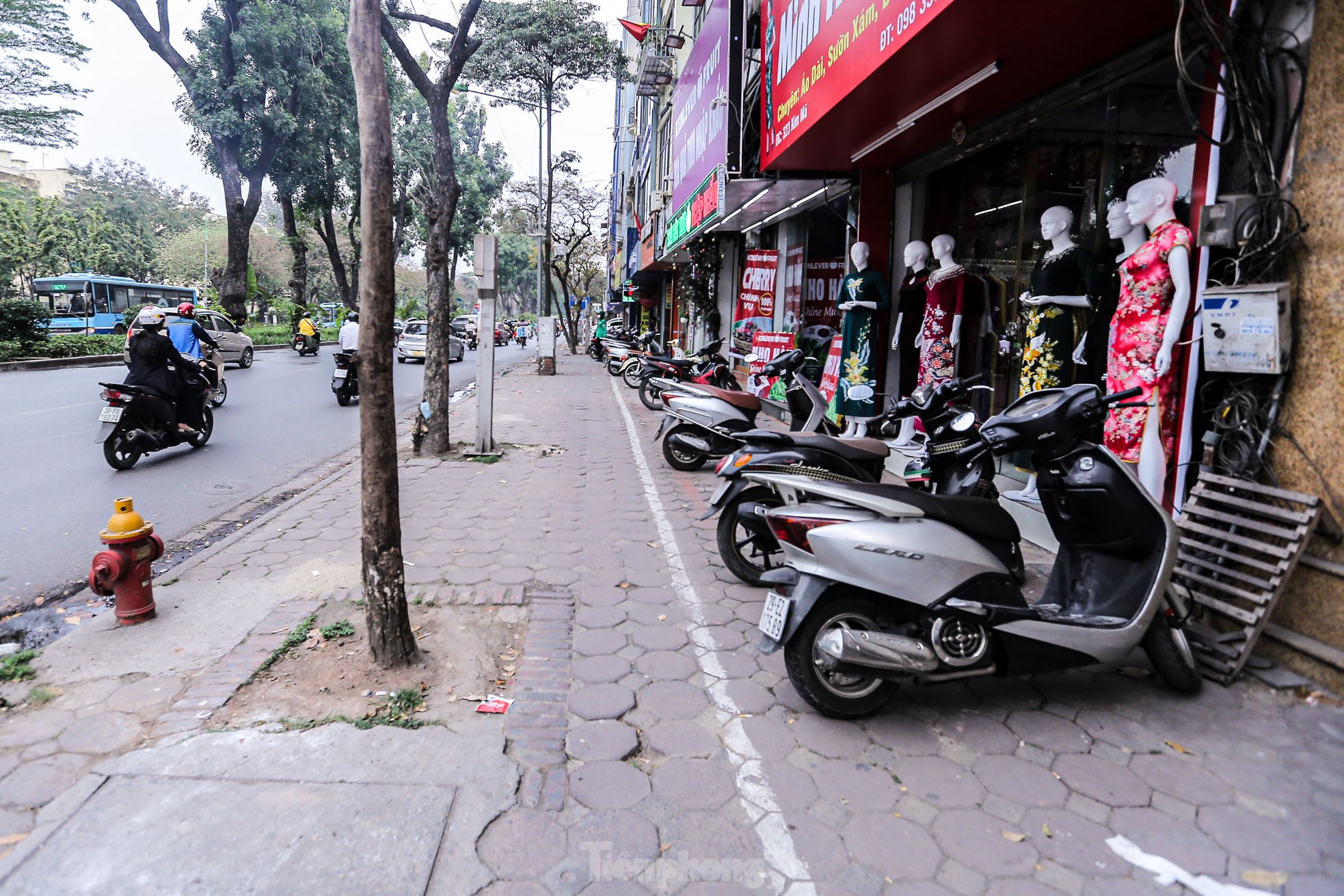 Vạch kẻ đường chia đôi vỉa hè Hà Nội, phần dành cho người đi bộ chỉ rộng &quot;một viên gạch&quot; - Ảnh 1.