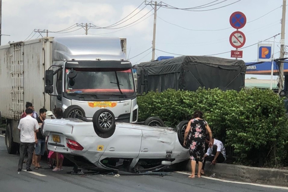 TP HCM: Ô tô chở 5 người phơi bụng trên Quốc lộ 1 - Ảnh 1. TP HCM: Ô tô chở 5 người phơi bụng trên Quốc lộ 1 - Ảnh 1.