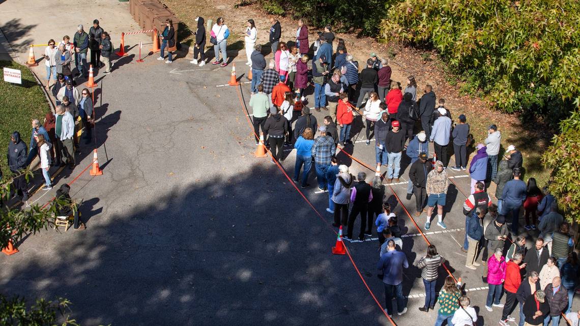 A line curves around the parking lot of the Herb C. Young Recreation Center in Cary, N.C., Thursday morning, Oct. 17, 2024, as people wait to cast their ballots on the first day of early voting in North Carolina. Scott Sharpe ssharpe@newsobserver.com