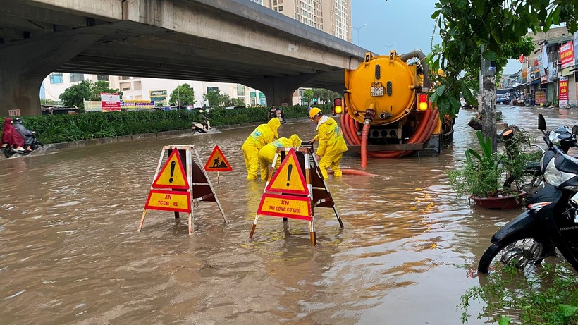 Trường học ở Hà Nội bất ngờ ngập sau trận mưa đêm, phụ huynh chật vật đưa con đến lớp - Ảnh 1.