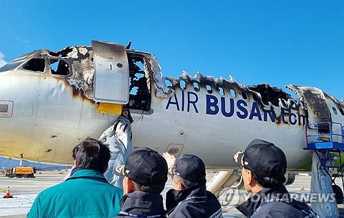 A fire-damaged airplane stands at Gimhae International Airport in Busan, some 320 kilometers southeast of Seoul, on Jan. 29, 2025, in this photo provided by the municipal government of Busan, a day after the plane caught fire while preparing to take off, prompting 176 passengers and crew members to evacuate. (PHOTO NOT FOR SALE) (Yonhap)