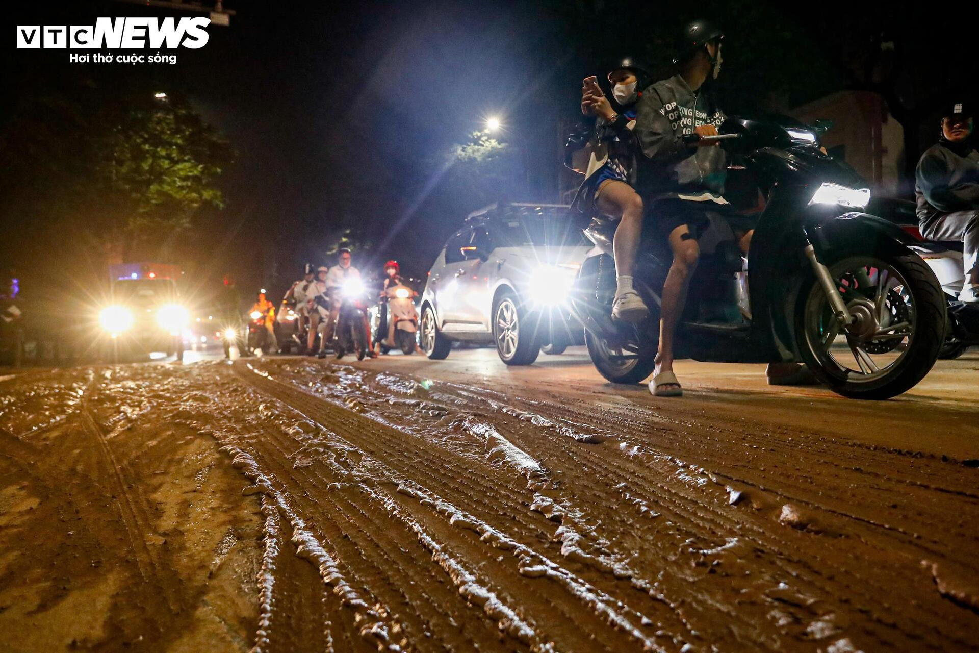 Bùn nhão tràn khắp đường, hàng loạt xe máy ngã sõng soài ở Hà Nội - Ảnh 2.