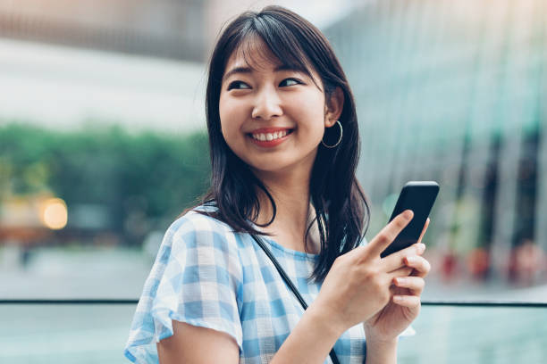 cheerful-japanese-girl-checking-messages-17540331081331088023441-1754060954011-1754060954176472127798.jpg