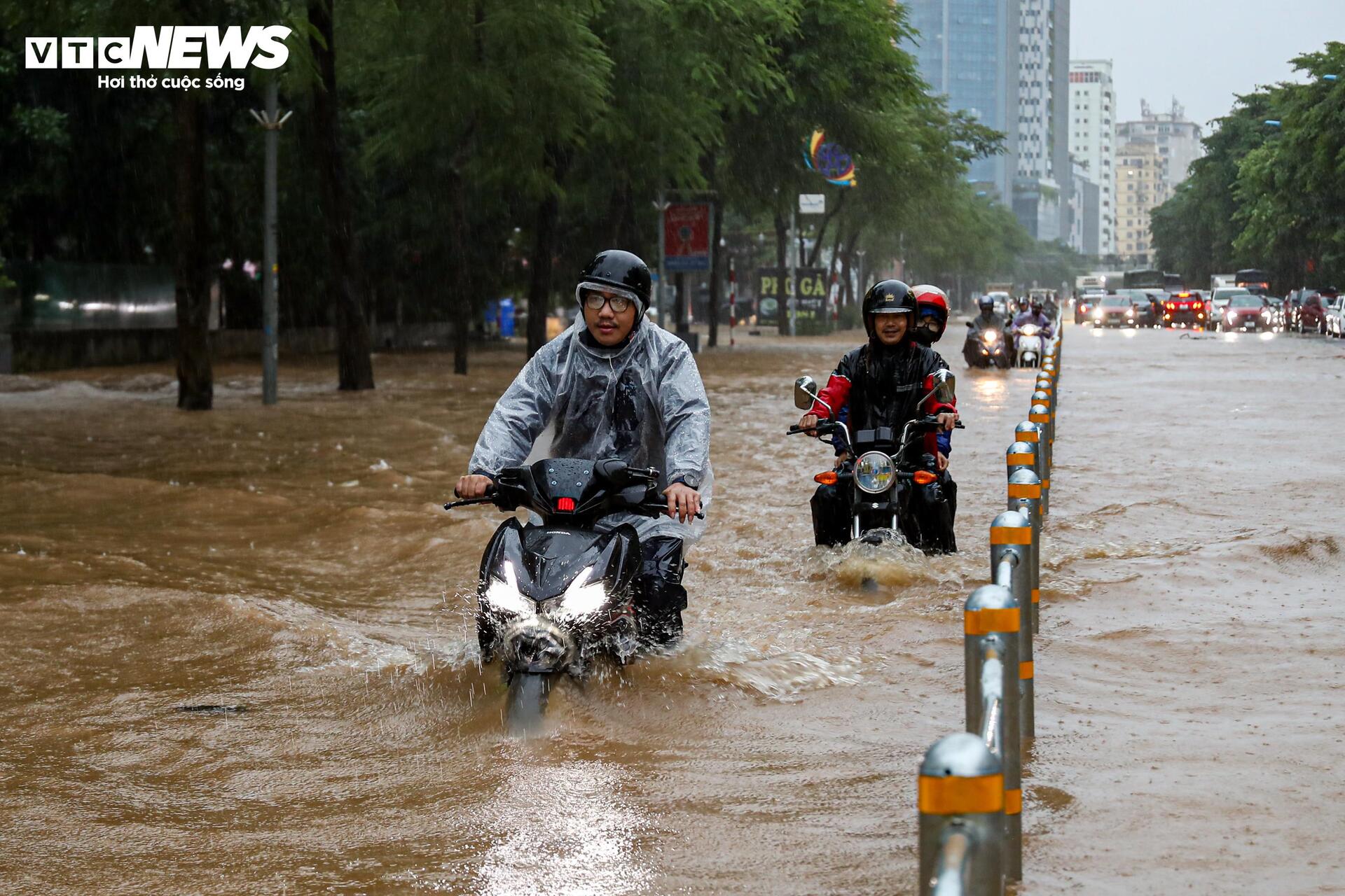 Nước ngập lút bánh xe, người Hà Nội dò dẫm tìm đường về nhà - Ảnh 29.