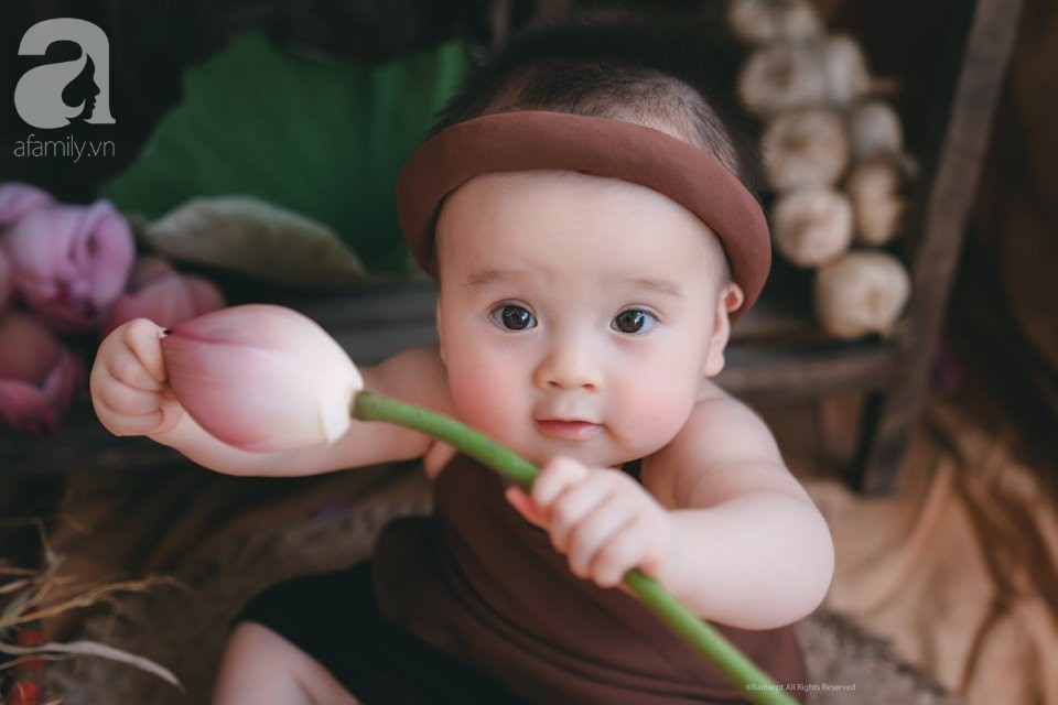 Một bức ảnh đáng yêu với em bé nhỏ trong ánh sáng mặt trời, ngắm hoa sen rực rỡ cực kỳ đáng yêu. Hãy cùng thưởng thức khu vườn nở rực rỡ này và cảm nhận sự thanh bình và hạnh phúc.