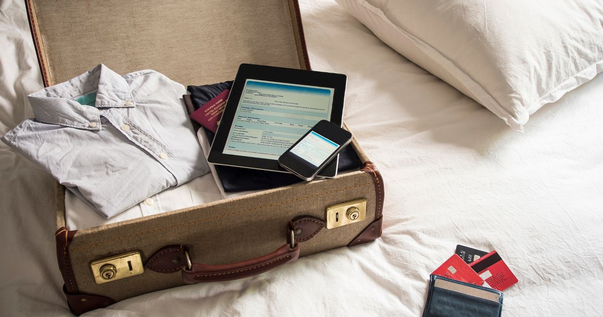 PROD-Open-suitcase-on-bed-with-digital-tablet-and-mobile-phone