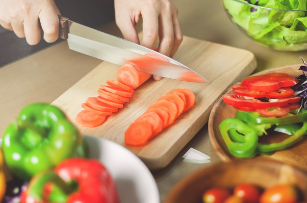 female-hands-cutting-carrot-vegetables-cooking-vegan-food_40048-12 (1)