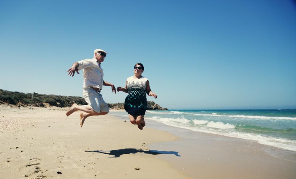 Couple-Jumping-on-Beach-1200x727