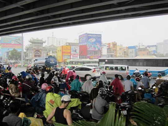 Số người đứng trú mưa ngày càng đông khiến giao thông qua nút giao thông này gặp ùn ứ và trở nên hỗn loạn