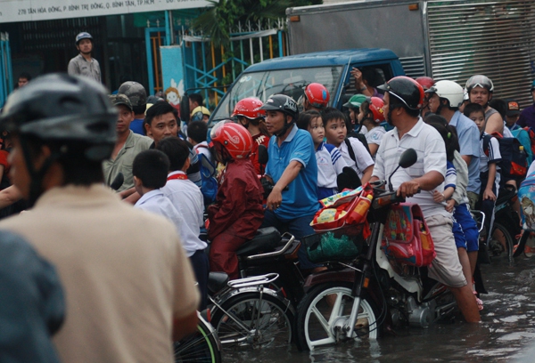 Phụ huynh bì bõm cõng con vượt 