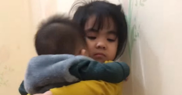 4-year-old girl carries her sick brother in the middle of the night, the boy stops crying and leans on her shoulder
