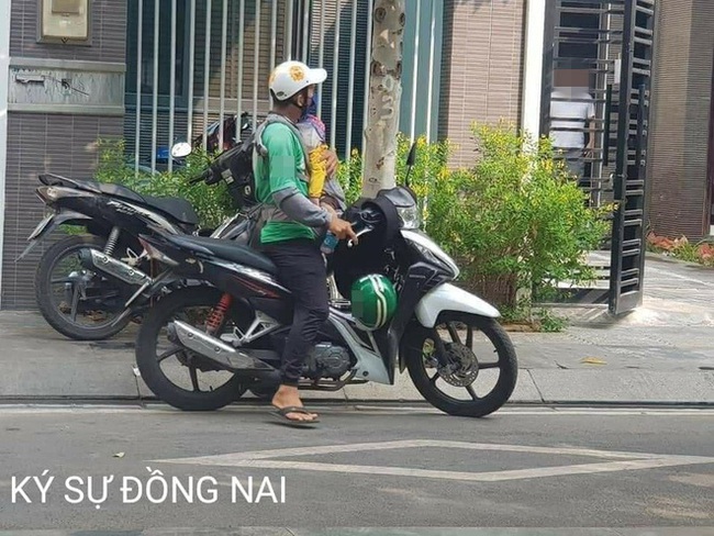 Hình ảnh ông bố trẻ đi giao hàng, địu con trước ngực áo khiến nhiều người cay mắt - Ảnh 1. Hình ảnh ông bố trẻ đi giao hàng, địu con trước ngực áo khiến nhiều người cay mắt - Ảnh 1.