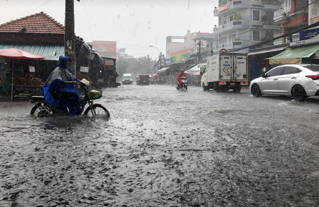 TP.HCM: Mưa lớn khiến đường phố như sông, người dân ngao ngán khi nước tràn vào nhà, bán buôn ế ẩm - Ảnh 1.