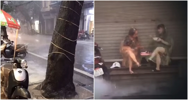 Giữa cơn mưa rào tầm tã ở Hà Nội, dân tình &quot;cạn lời&quot; khi bắt gặp 2 người phụ nữ vừa mặc áo mưa vừa buôn dưa rôm rả trên vỉa hè - Ảnh 1.