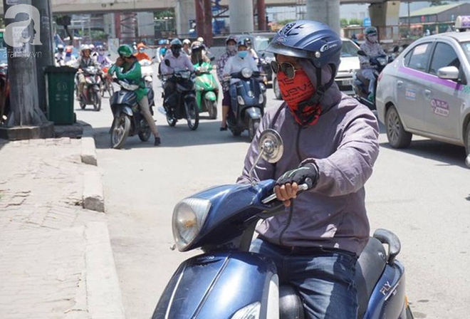 Hà Nội trải qua ngày nắng nóng gắt nhất từ đầu mùa, người dân bịt kín mít khi ra đường - Ảnh 11.