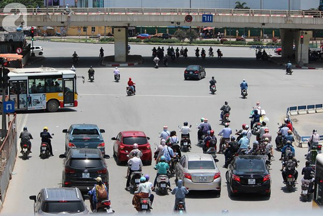 Hà Nội trải qua ngày nắng nóng gắt nhất từ đầu mùa, người dân bịt kín mít khi ra đường - Ảnh 1.