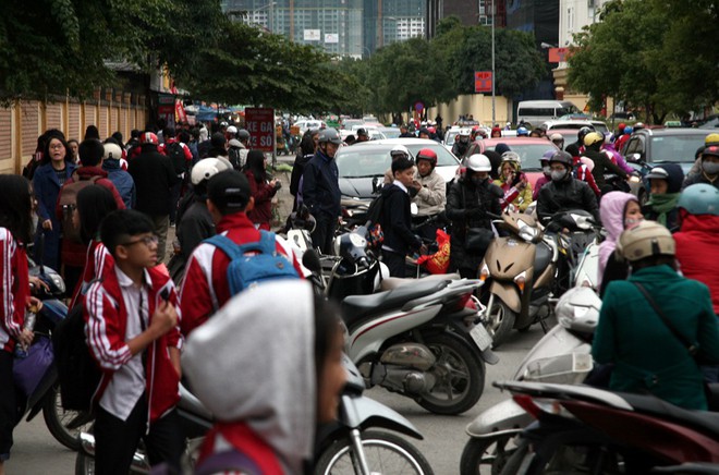 Hà Nội chuyển rét đậm, cha mẹ khoác áo mưa đón con trẻ từ trường về nhà dù trời tạnh ráo - Ảnh 6.