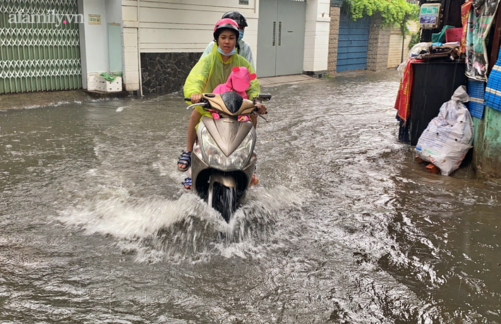 Mưa lớn liên tục nhiều giờ gây ngập sâu, người dân TP.HCM ngao ngán tìm cách chắn cửa ngăn nước tràn vào nhà - Ảnh 3.