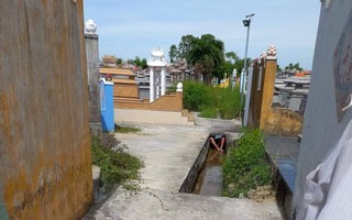 Người đàn ông bị bỏng nặng nằm dưới mương nước trong nghĩa trang