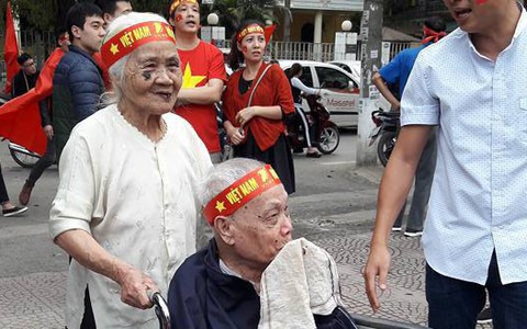 Hình ảnh rất đẹp: Cụ bà đẩy xe lăn đưa cụ ông đi cổ vũ đội tuyển U23 Việt Nam
